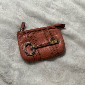 Burnt orange Fossil wallet featuring a unique key design